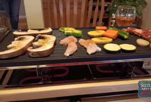 meat and vegetables sizzling on table top grill