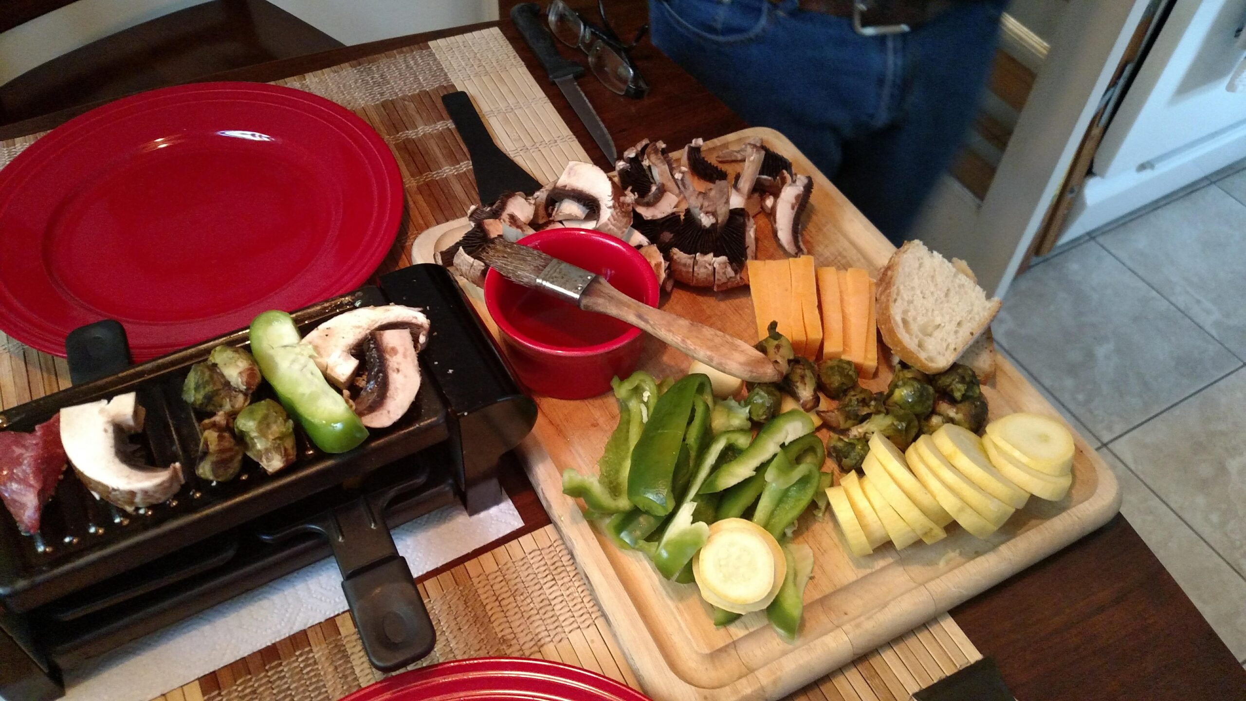 What Is a Raclette Grill? mini raclete grill with raw food on board